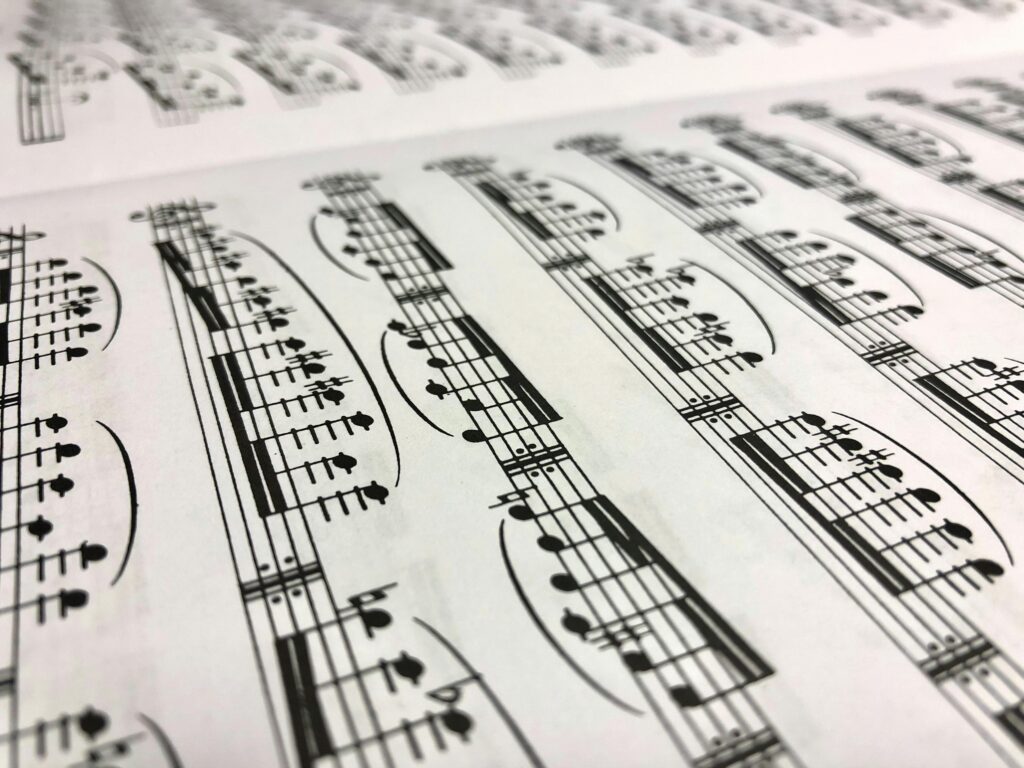 Detailed close-up shot of a musical sheet displaying notes in monochrome style.